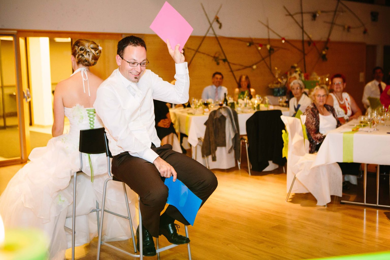 Couple play Mr & Mrs at wedding reception