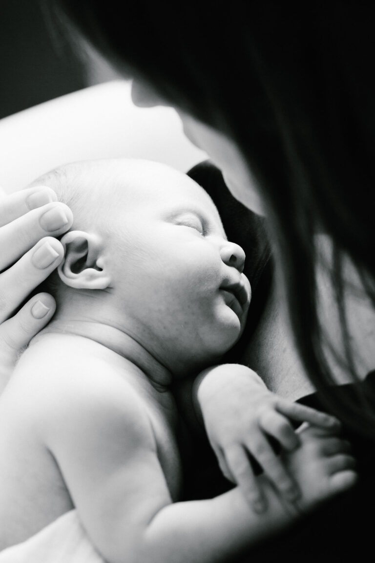 A tender newborn moment at a professional photo shoot in Lausanne