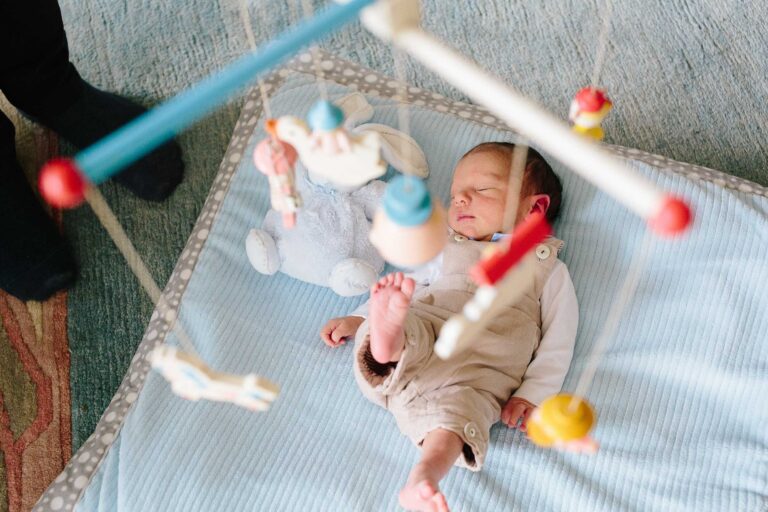 Newborn baby with mobile