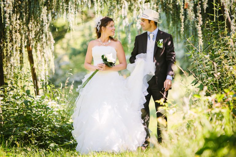 Bride and groom beneath the trees