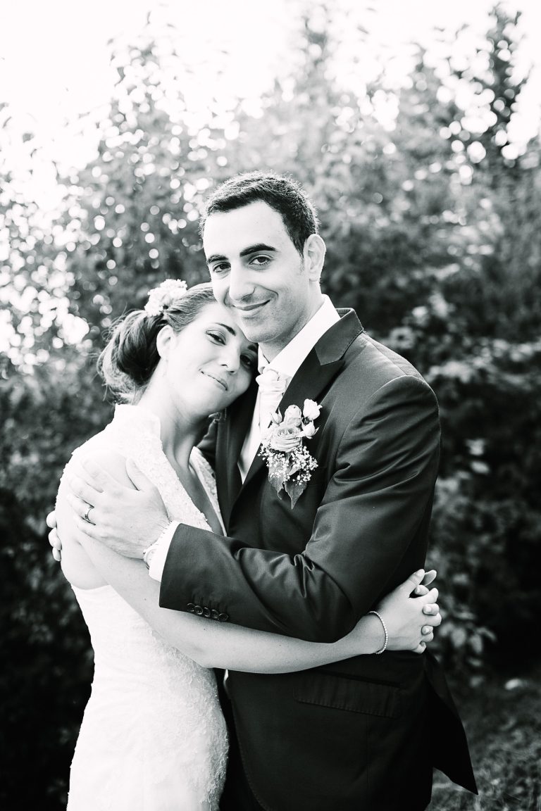 Bride and groom hug for a portrait