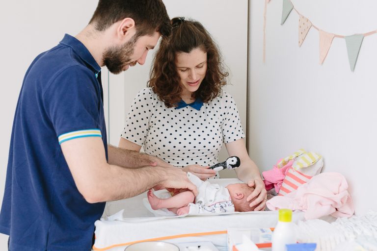Mum and dad brush newborn's hair